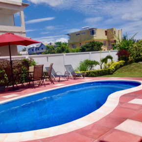 Cardamon Villa is a 2 bedroom with 1 bathroom and seperate toilet detached house with AC and swimming pool , 5 minutes walk from Flic en Flac public beach